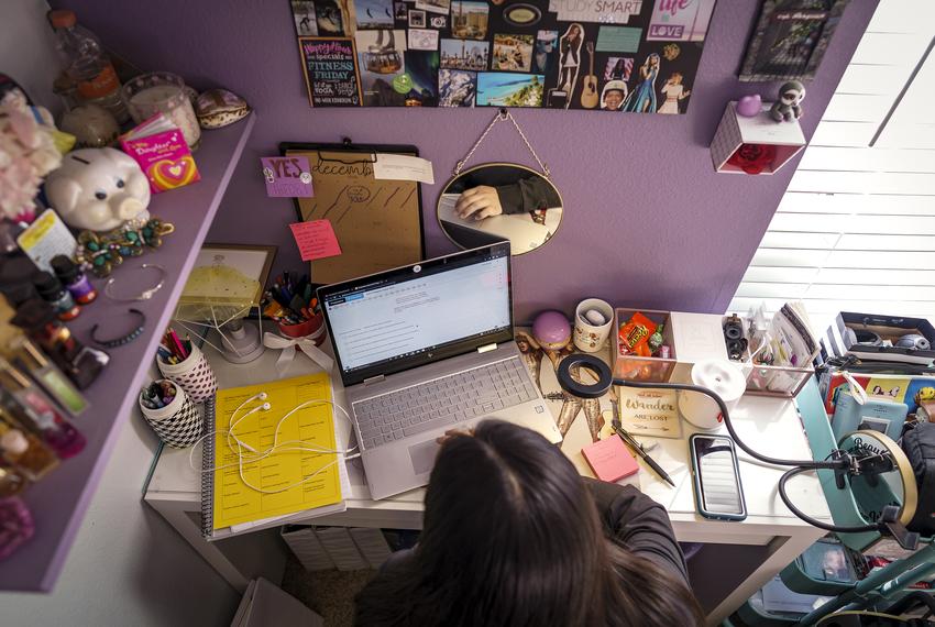 Isabel Suarez works on homework prior to the start of the school day from her home in Pflugerville on Dec 9, 2020.