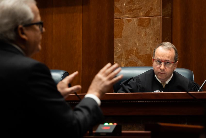 Texas Supreme Court Justice John Devine listens to Douglas Alexander make oral arguments in the cases Abbott v. City of San Antonio, Abbott v. Jenkins, and Abbott v. Harris County, Feb. 22. 2023 in Austin. The cases were consolidated for oral arguments, as they all concern whether an executive order barring local mask mandates falls within the scope of authority granted to the Governor under the Texas Disaster Act.