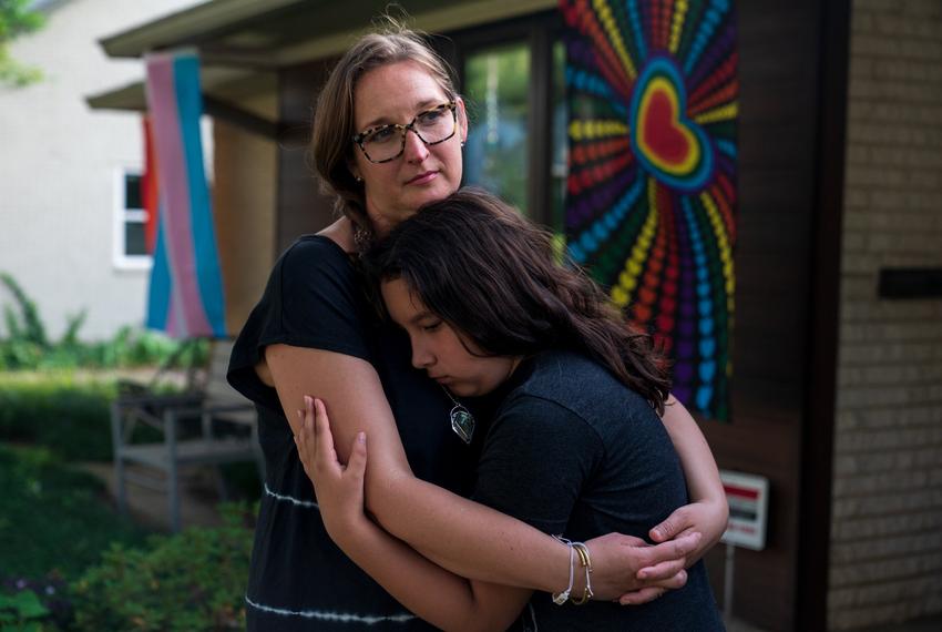 DALLAS, TEXAS - Rachel Gonzales holds her daughter Libby Gonzales, 11, outside their home on June 26, 2021. Libby was seven when she testified against the "bathroom bill" at the Texas Capitol.