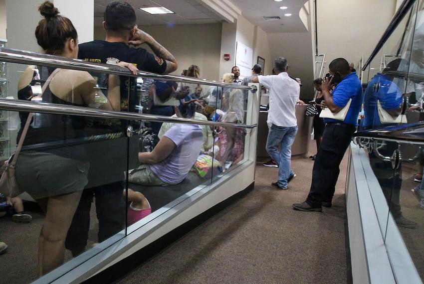 People wait at a driver license reclamation clinic in Austin on June 22, 2018.