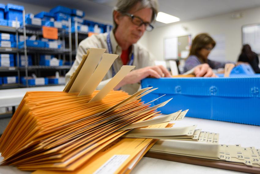 Ballot by mail clerk Jim Ragland organized ballot packages at the Travis County Elections Division in Austin in 2014. 