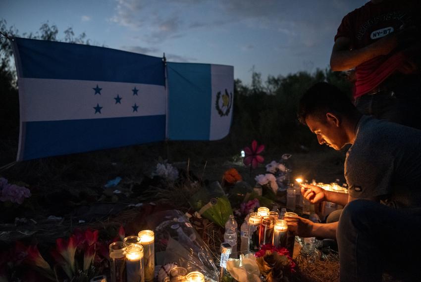 Jesus Vasquez, originally from Honduras, lights candles at a makeshift memorial to the 53 people who died after being left in a truck trailer in a human smuggling operation, on June 30, 2022 outside San Antonio.