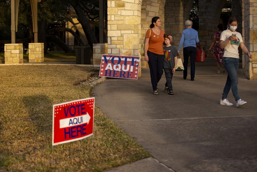 Denise Simmons and her son, Graham, 8, walk out of Austin Oaks Church after waiting 30 minutes to vote on election day on March 1, 2022.