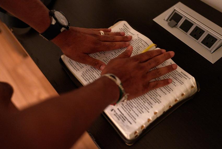 Arango places his hands on a Bible he traveled with through seven countries and the Darién Gap, a stretch of jungle between Panama and Colombia. As the smoke and flames spread through the cell inside the detention center, Arango said, he fell to the floor and prayed.