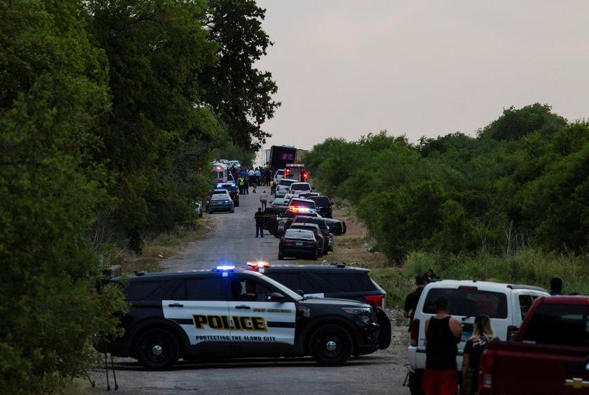 Law enforcement officers work at the scene where people were found dead inside a trailer truck in San Antonio on June 27, 2022.