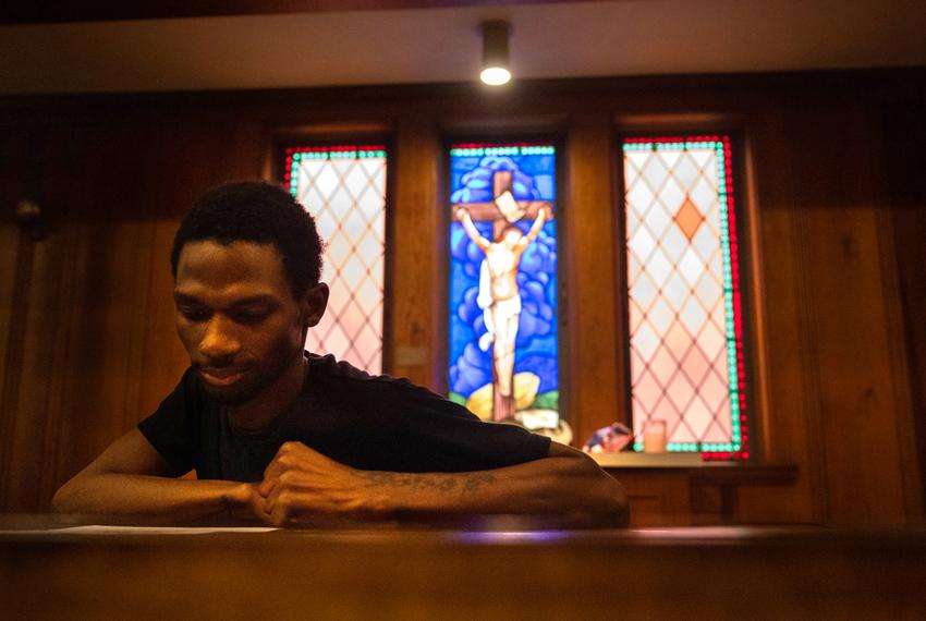 Brandon Williams looks at a positive affirmation card during a Youth Voices Empowered event at Montrose Grace Place on May 1 in Houston. Williams was suspended multiple times from Houston ISD's Yates High School while he was homeless.