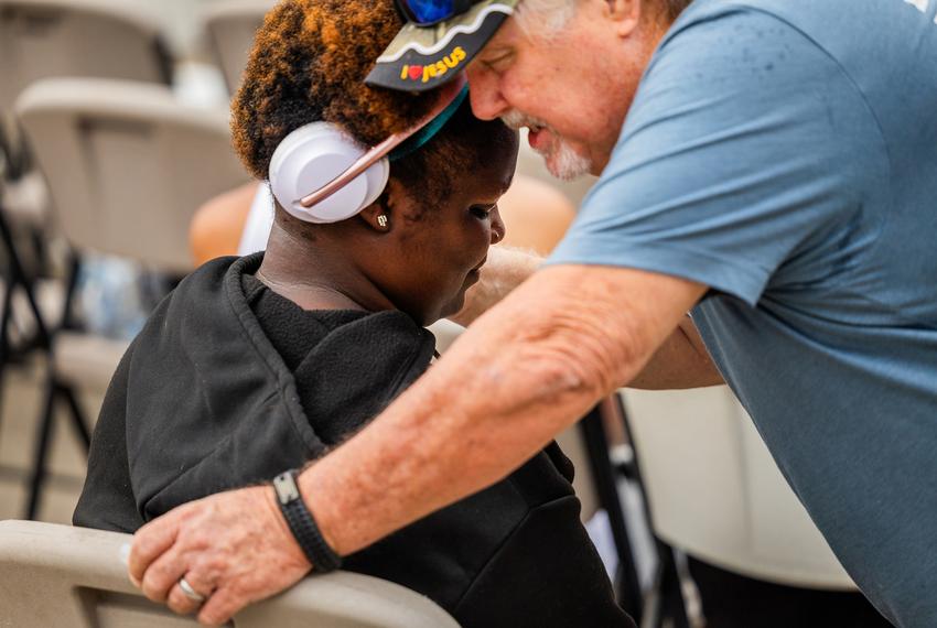 Danielle Stephen closes her eyes while Mike MacLaughlin prays for her at a Montrose Street Reach service.