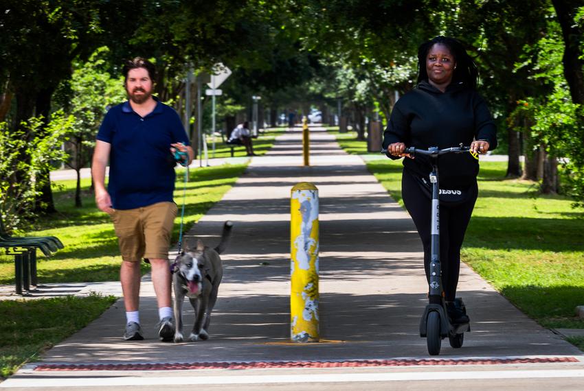 Danielle Stephen, 20, rides her scooter by the trail behind her apartment in the East End, Thursday, April 18, 2024, in Houston.