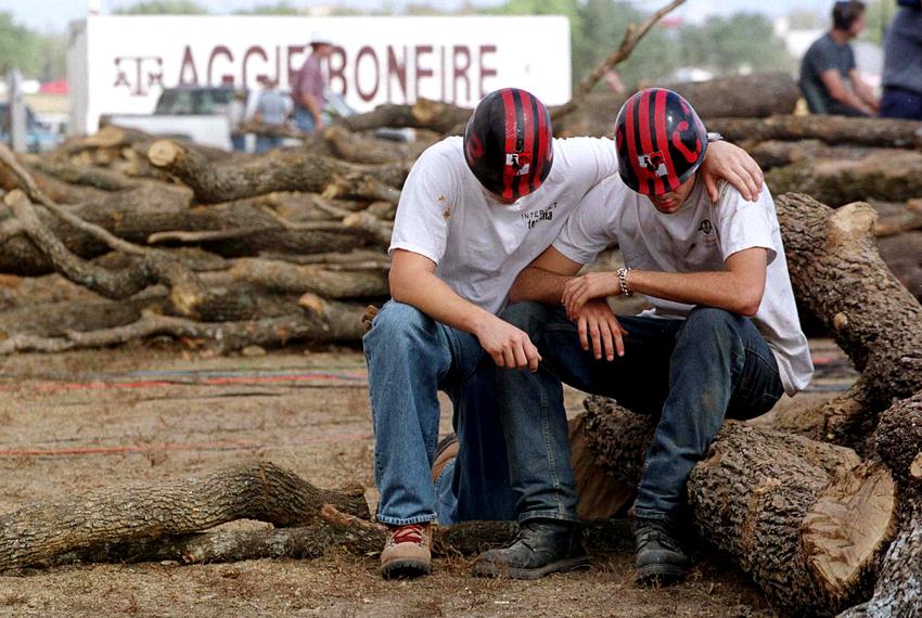 Texas A&M students, who wished not to be identified, mourn the loss of fellow students after a bonfire log structure collapsed on Nov. 18 in College Station, killing 6 students. The bonfire, made of thousands of logs, was a longtime annual tradition ahead of Texas A&M/UT-Austin football games.