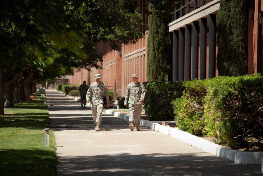 Two U.S. soldiers walk through the historic area on Ft. Bliss Army installation on April 23, 2012. The Army contracted energy efficiency consulting company Johnson Controls for the installation of a $16 million solar energy system. With the improvements Ft. Bliss, which has about 30,000 soldiers and 1.1 million acres, is expected to save $39 million in energy costs over the next 24 years.